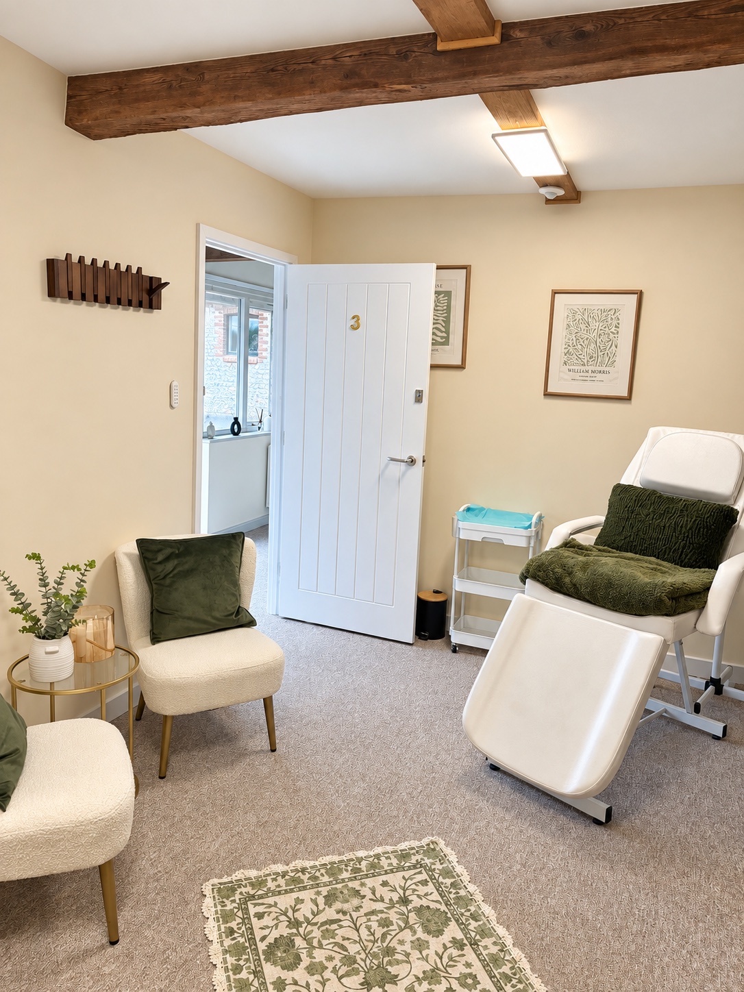 A warm, private wellness room at Astons with original beams and comfortable treatment furniture